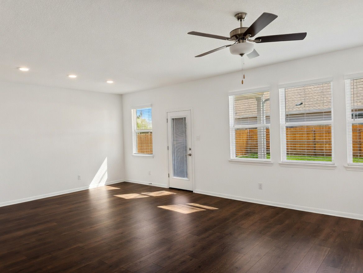 4002 Wynn Road Hutto, TX 78634 - Photo 18 of 29 Unfurnished room with dark wood-type flooring and a ceiling fan