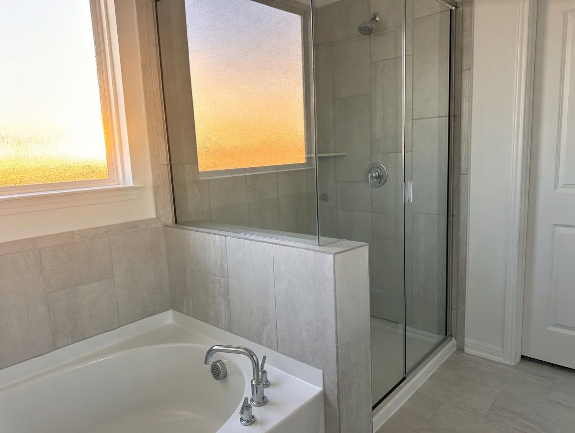 4002 Wynn Road Hutto, TX 78634 - Photo 19 of 29 Full bathroom with a shower stall and a bath