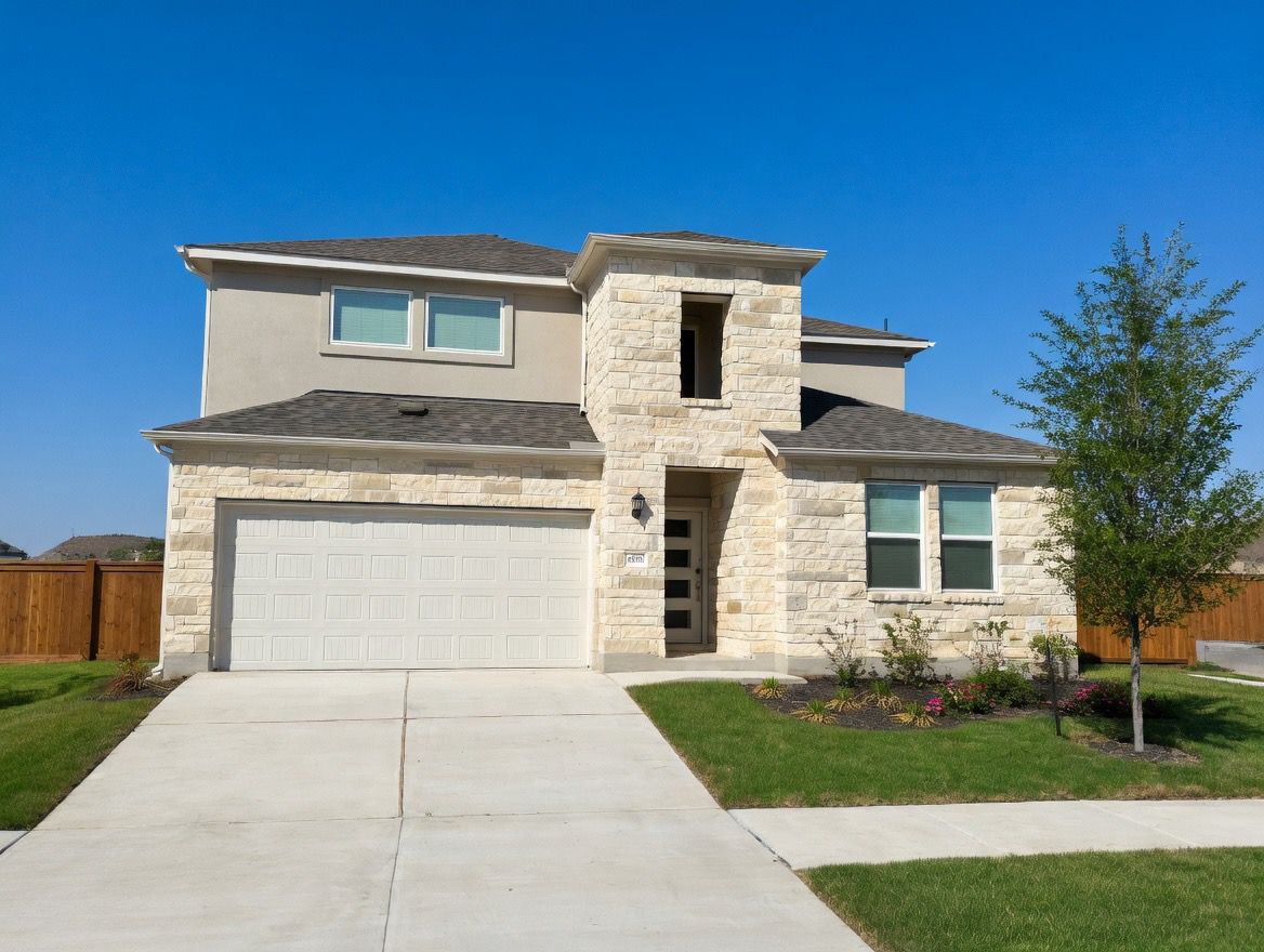 4002 Wynn Road Hutto, TX 78634 - Photo 2 of 29 View of front facade featuring stone siding and driveway