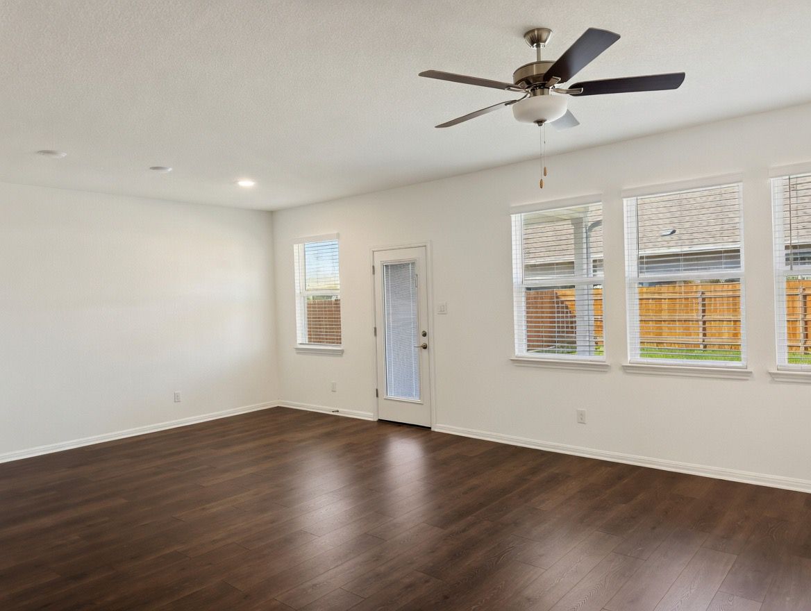 4002 Wynn Road Hutto, TX 78634 - Photo 22 of 29 Unfurnished room with dark wood-type flooring, ceiling fan, and a textured ceiling
