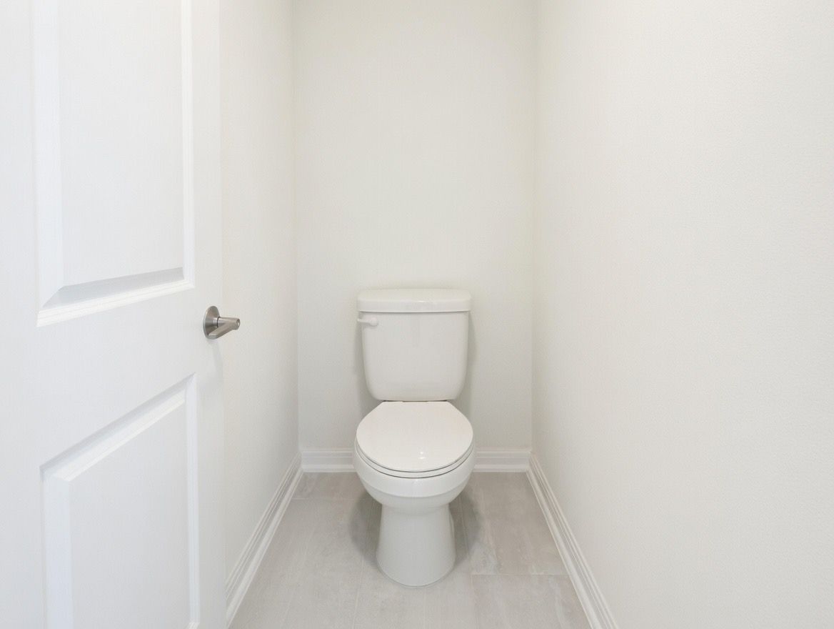 4002 Wynn Road Hutto, TX 78634 - Photo 25 of 29 Bathroom featuring toilet and light tile patterned floors