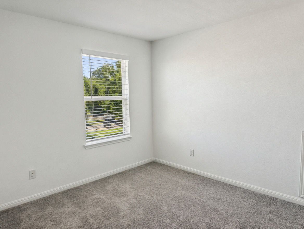 4002 Wynn Road Hutto, TX 78634 - Photo 26 of 29 Carpeted spare room featuring baseboards