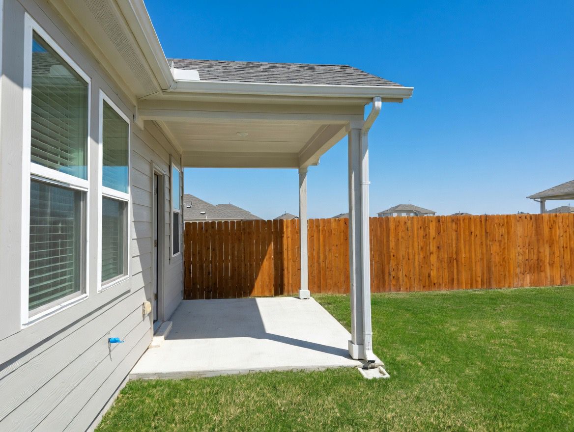 4002 Wynn Road Hutto, TX 78634 - Photo 29 of 29 Fenced yard with a patio