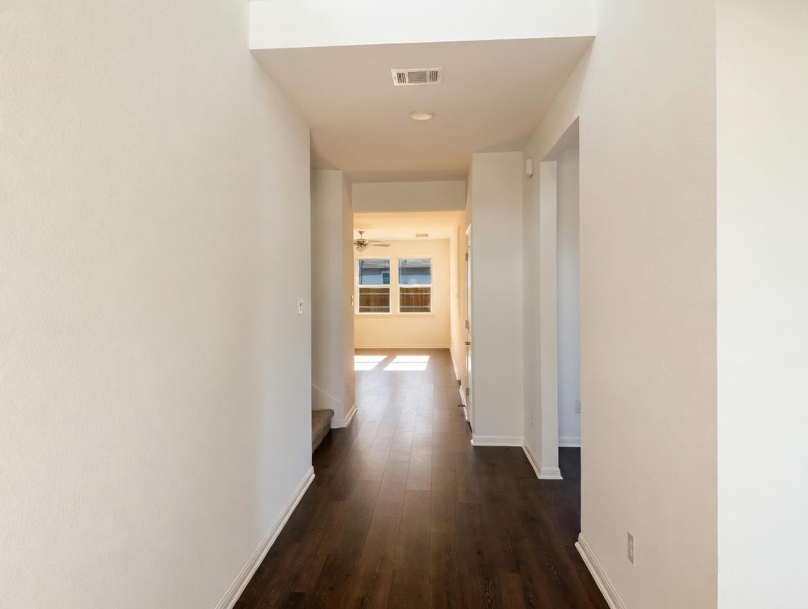 4002 Wynn Road Hutto, TX 78634 - Photo 5 of 29 Corridor with baseboards and dark wood-style flooring