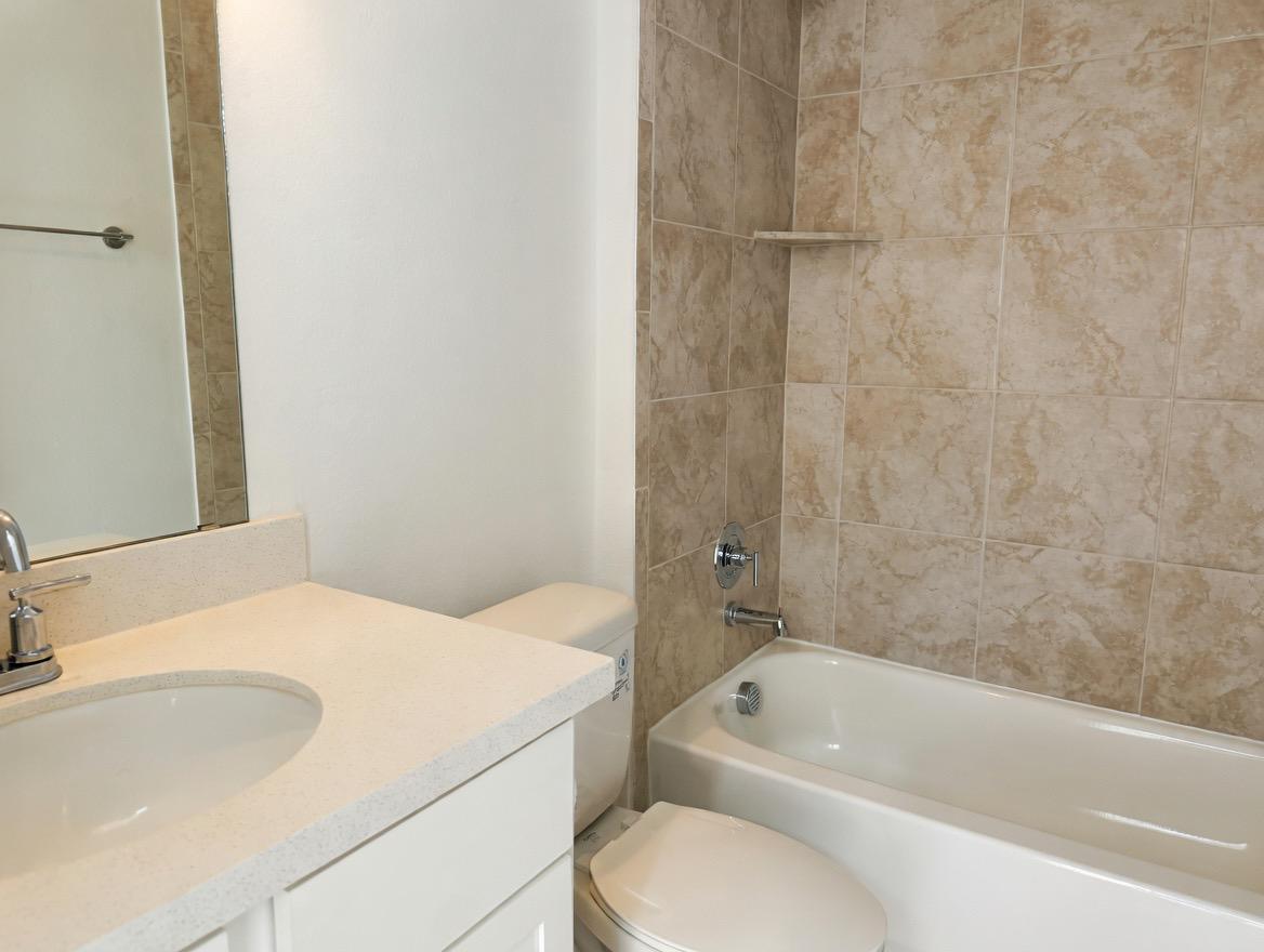 4002 Wynn Road Hutto, TX 78634 - Photo 6 of 29 Bathroom with vanity and washtub / shower combination