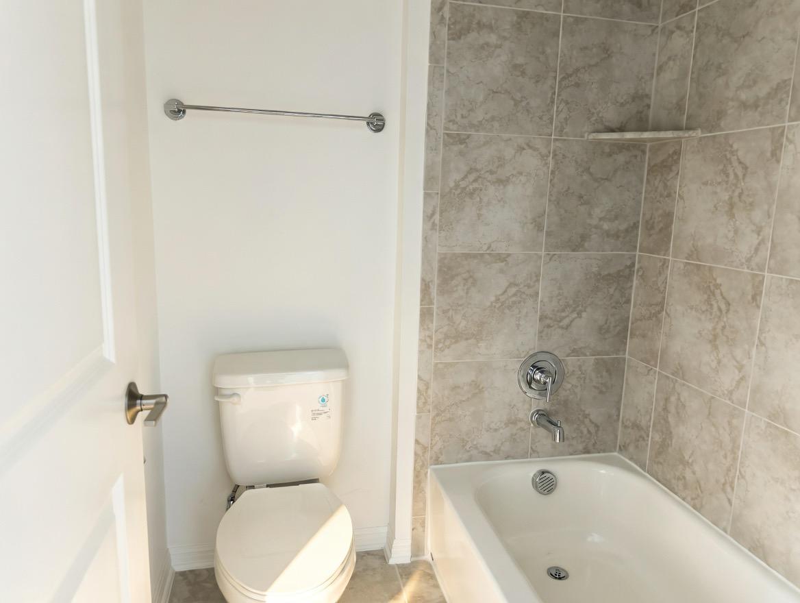 4002 Wynn Road Hutto, TX 78634 - Photo 9 of 29 Full bath featuring toilet and shower / washtub combination