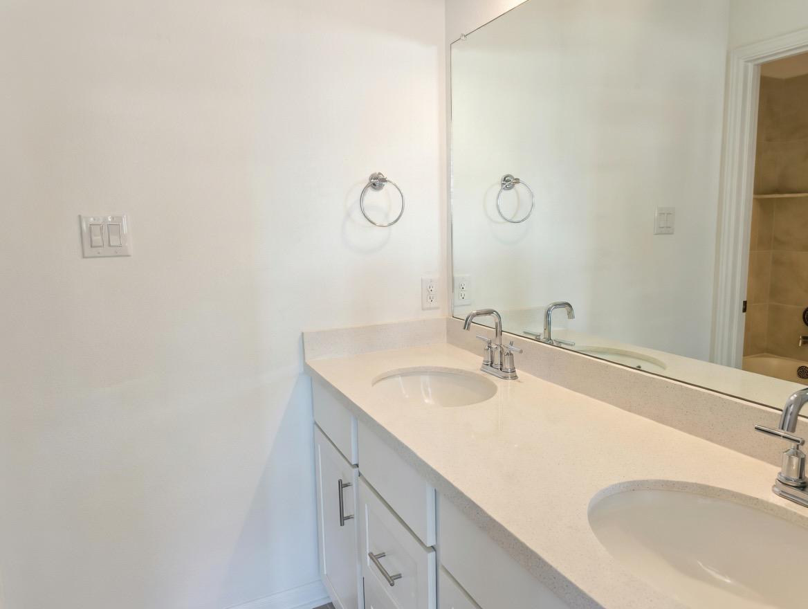 4002 Wynn Road Hutto, TX 78634 - Photo 10 of 29 Bathroom featuring double vanity and a bath