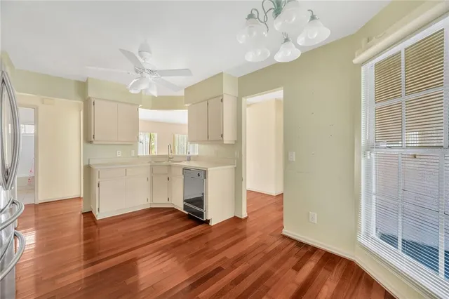 a view of a kitchen with wooden floor and a window