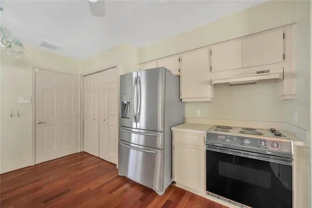 a kitchen with a stove top oven and refrigerator