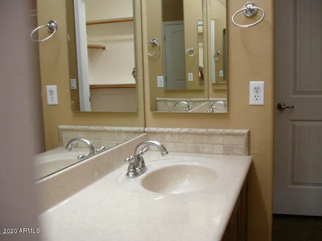 a bathroom with a sink a mirror and a shower