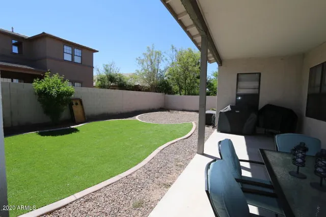 a view of a backyard with sitting area