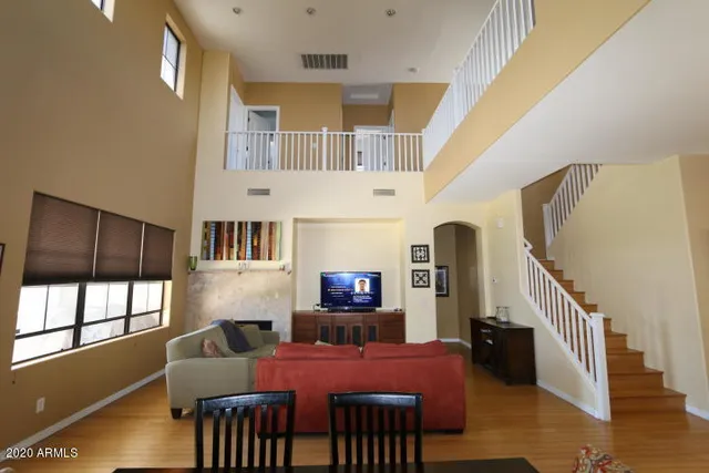 a living room with furniture a rug and a flat screen tv