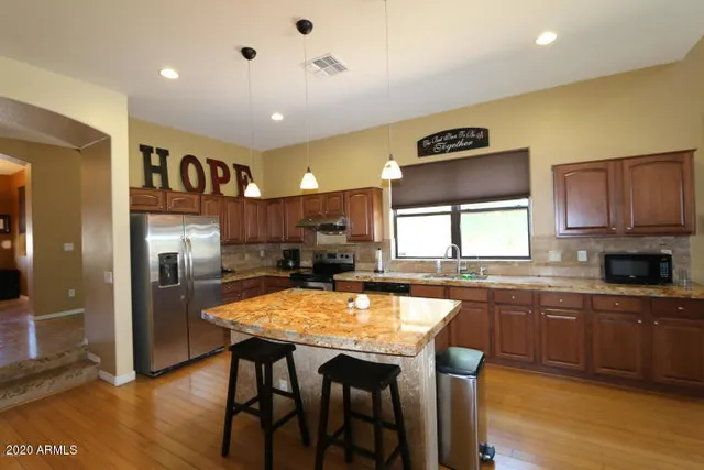 a large kitchen with a table and chairs in it