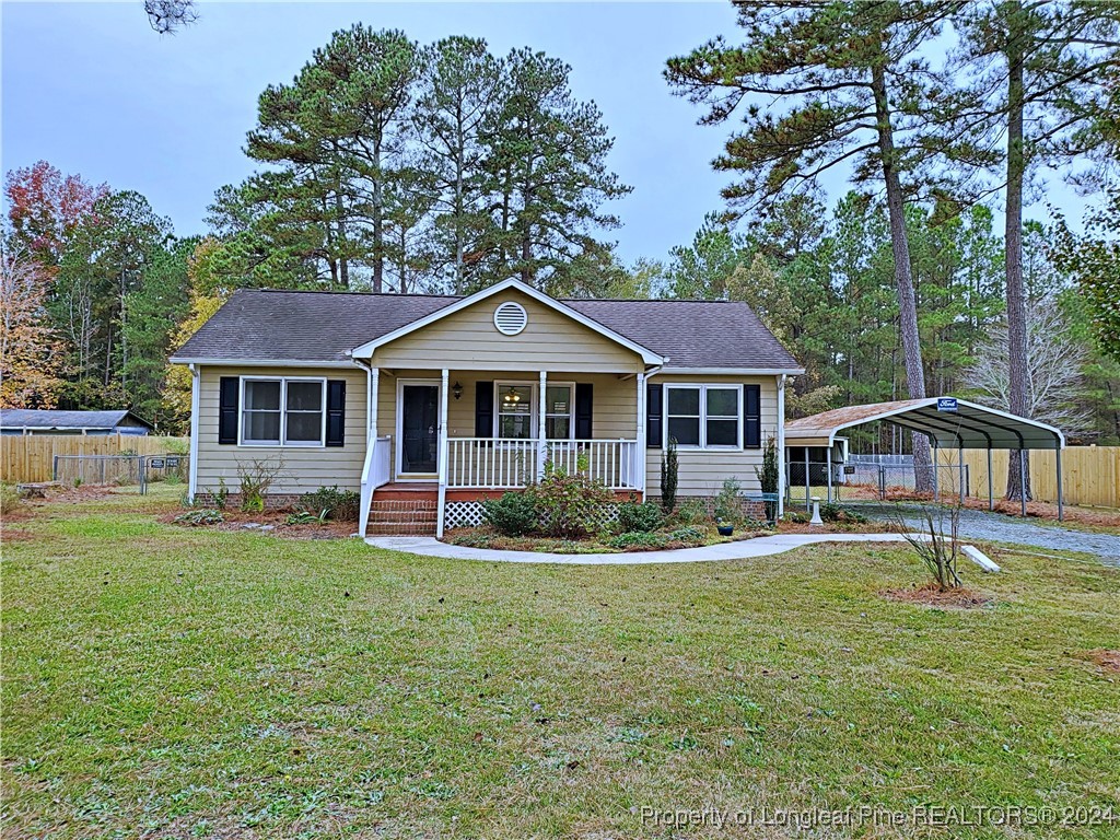 a front view of a house with a garden and trees