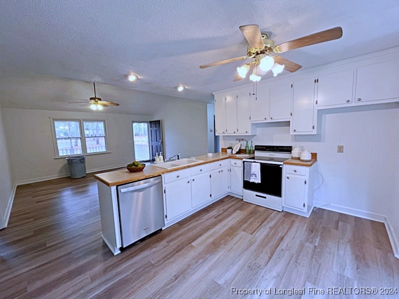 210 Cypress Road Cameron, NC 28326 - Photo 13 of 50 a kitchen with stainless steel appliances granite countertop a sink cabinets and wooden floor