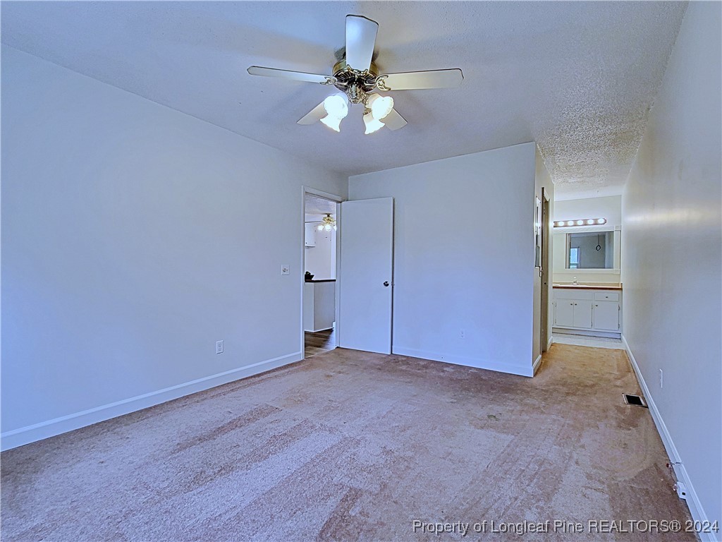 210 Cypress Road Cameron, NC 28326 - Photo 20 of 50 a view of an empty room with a ceiling fan