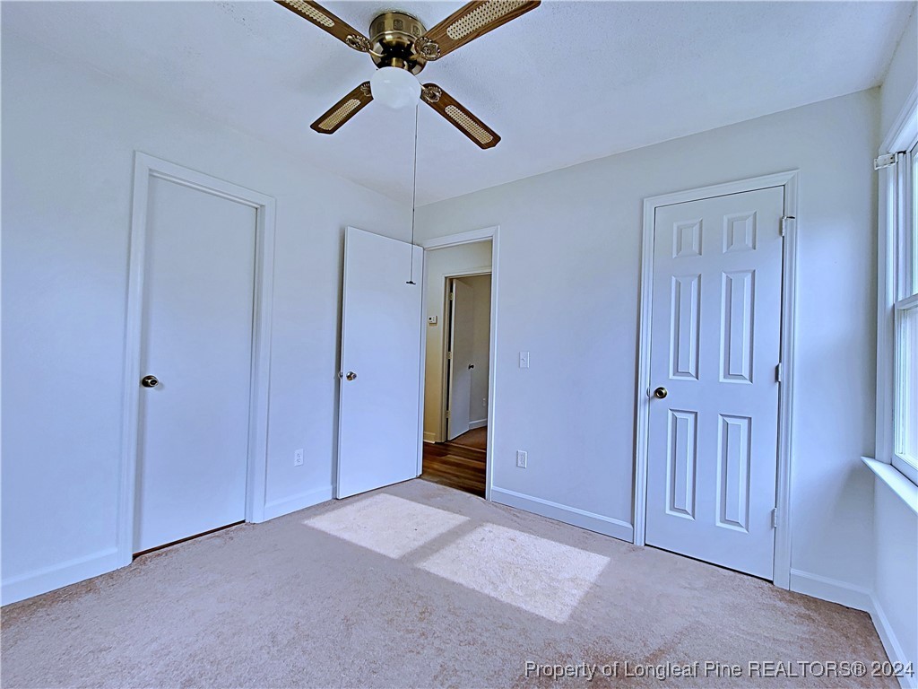 210 Cypress Road Cameron, NC 28326 - Photo 32 of 50 an empty room with closet and a chandelier fan