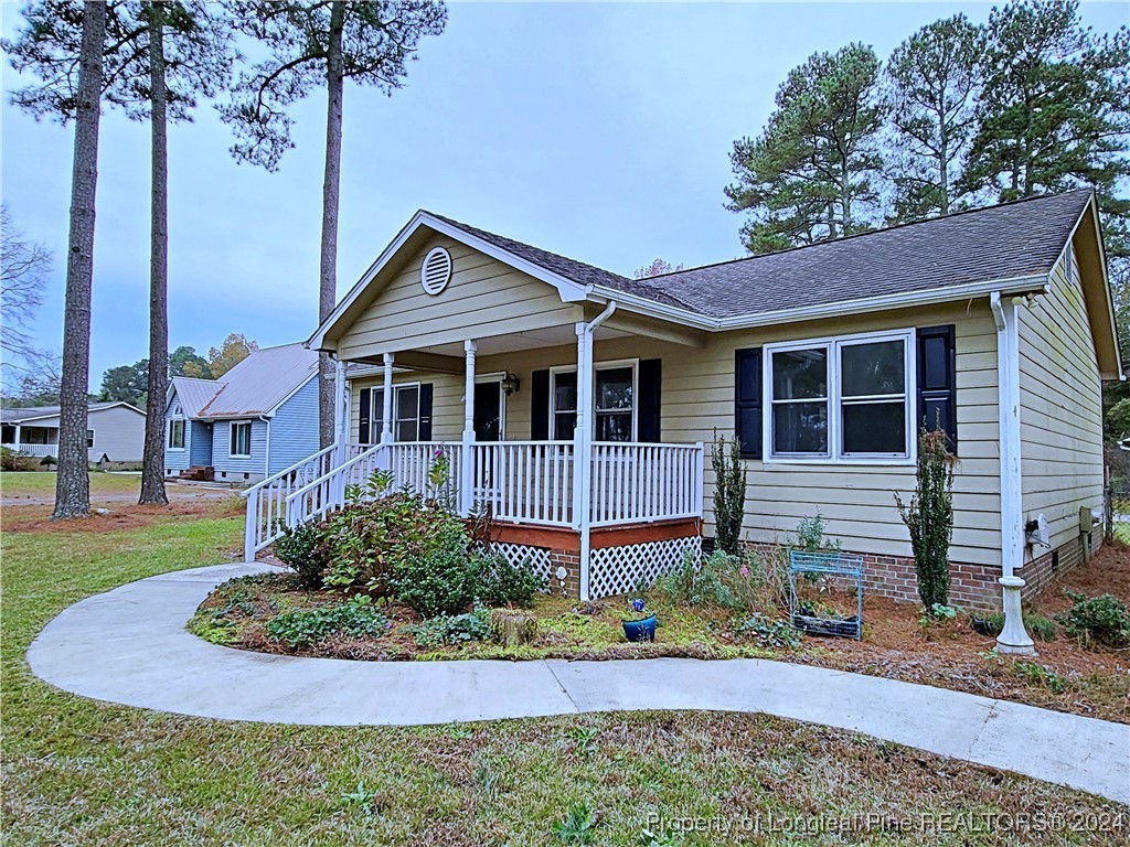 210 Cypress Road Cameron, NC 28326 - Photo 36 of 50 a front view of a house with a yard