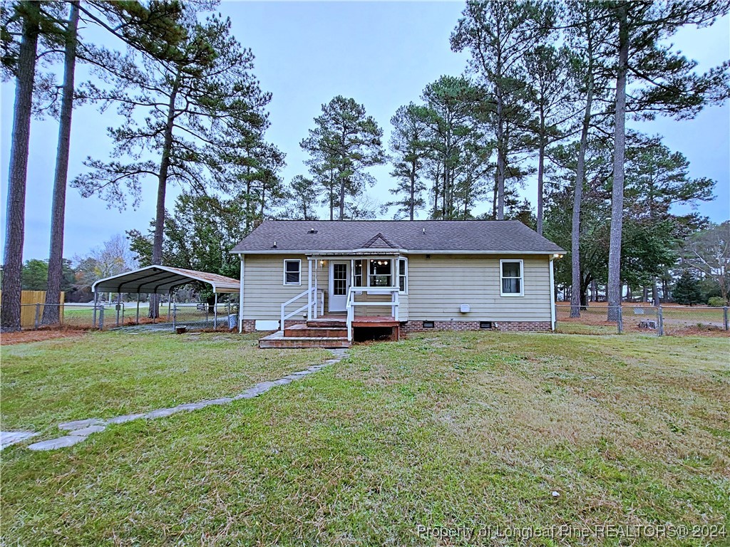 210 Cypress Road Cameron, NC 28326 - Photo 38 of 50 a front view of a house with a garden and trees