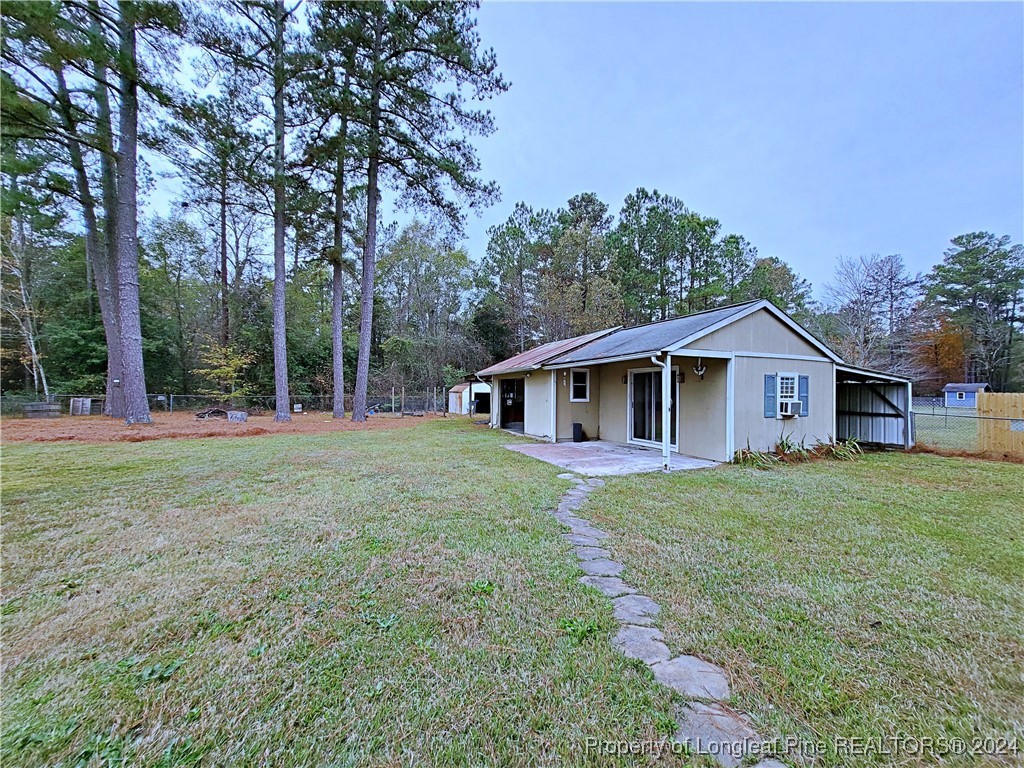 210 Cypress Road Cameron, NC 28326 - Photo 45 of 50 a front view of a house with a yard and trees