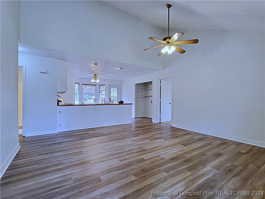 210 Cypress Road Cameron, NC 28326 - Photo 7 of 50 a view of a kitchen with a ceiling fan and wooden floor