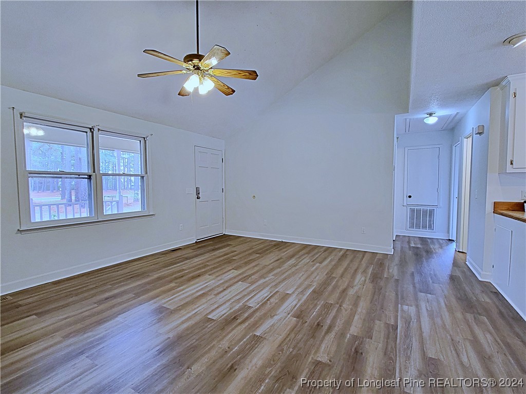 210 Cypress Road Cameron, NC 28326 - Photo 9 of 50 a view of an empty room with window and wooden floor