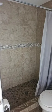 a bathroom with a toilet and a mirror