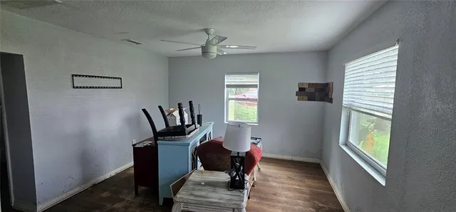 a view of a workspace with furniture and a window