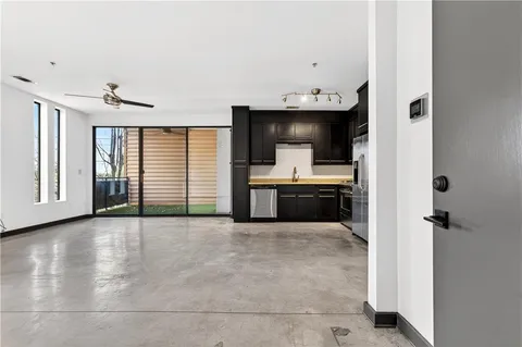 a view of a kitchen with an entryway and a window