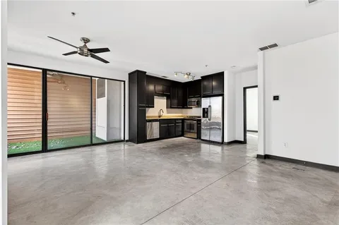 a view of a kitchen with refrigerator and a ceiling fan