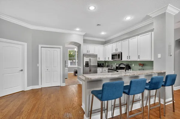 a kitchen with sink cabinets and wooden floor