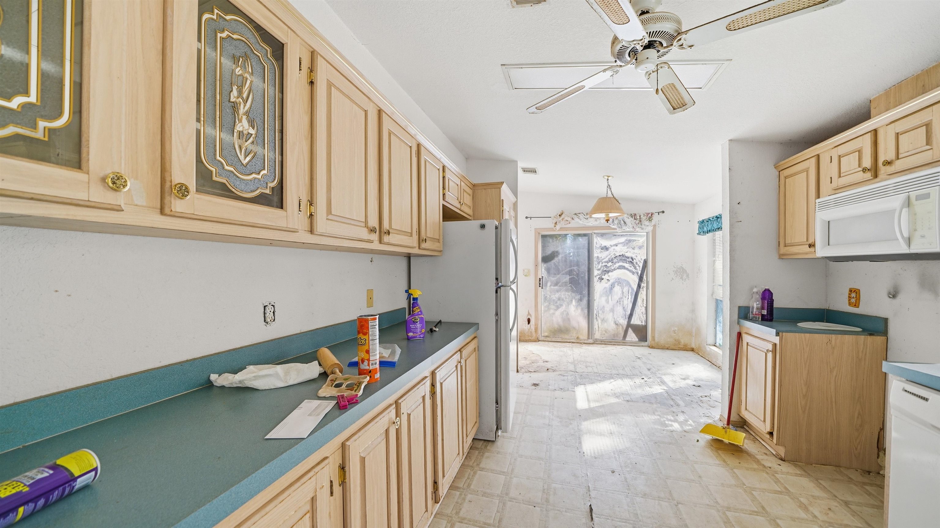 7451 Hilltop Street Keystone Heights, FL 32656 - Photo 14 of 24 a kitchen with stainless steel appliances granite countertop a sink dishwasher and a stove with wooden floor