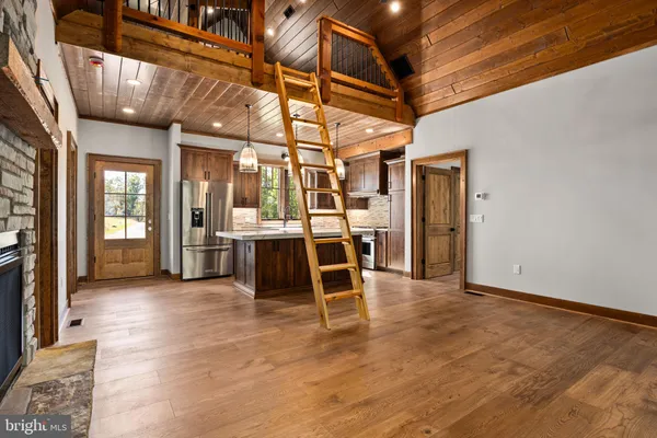 a view of a room with wooden floor