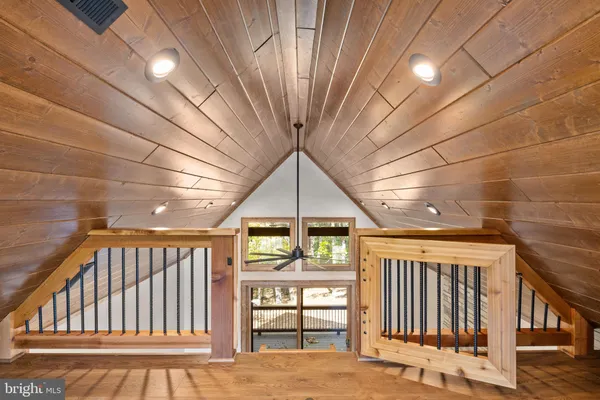 a view of a hallway with wooden floor and entryway