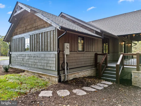 a view of a house with wooden fence and a stairs
