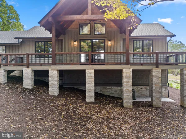 a front view of a house with a yard balcony and seating area