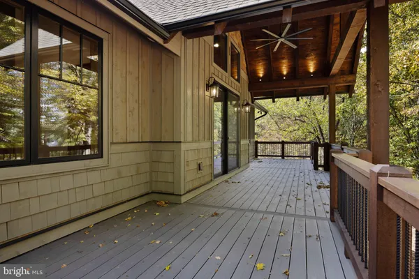 a view of a porch with wooden floor and outdoor space