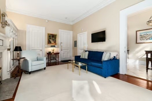 252 Commonwealth Avenue, Unit 4 Boston, MA 02116 - Photo 3 of 14 a living room with furniture and a flat screen tv