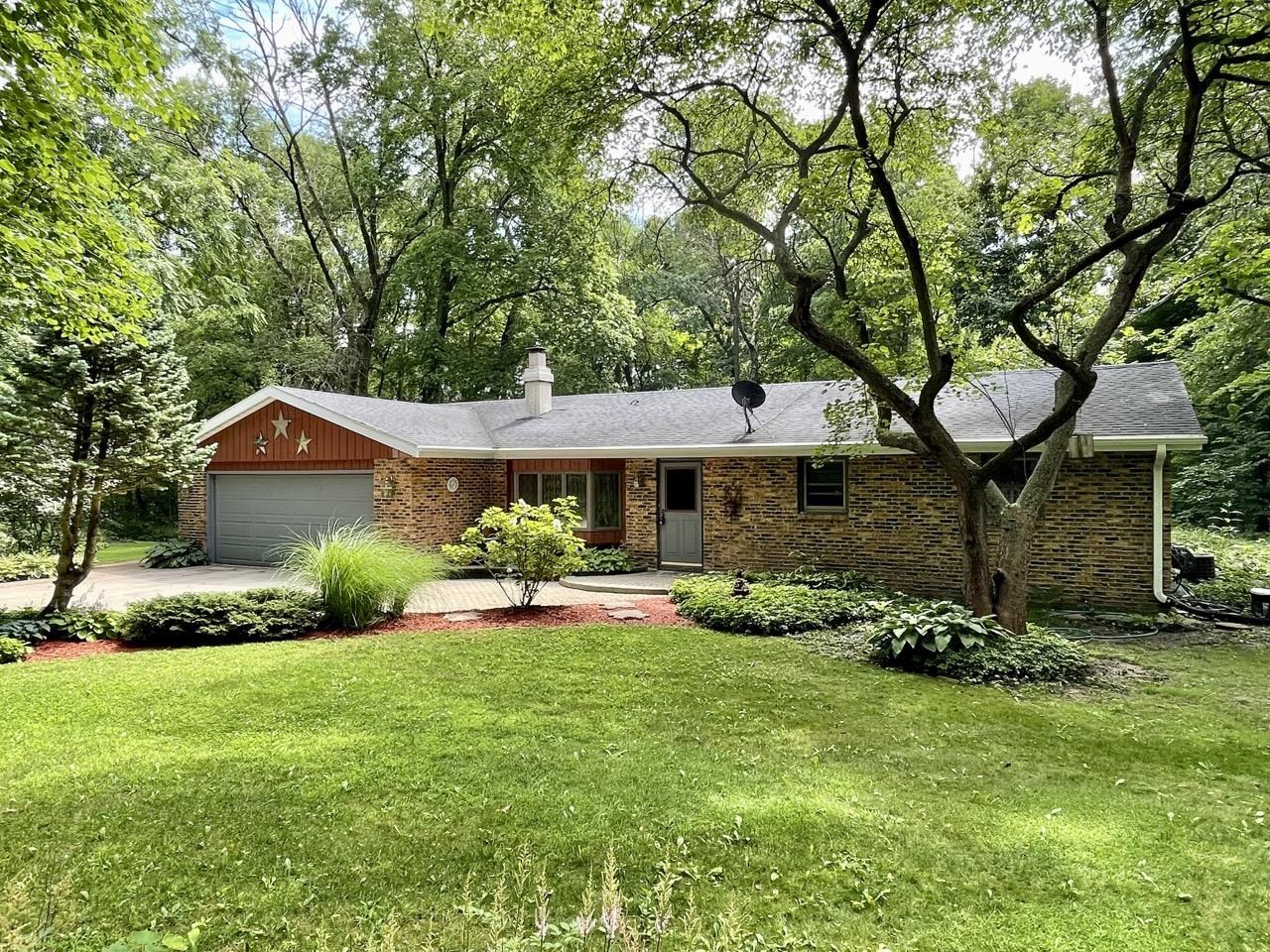 6840 Best Road Pecatonica, IL 61063 - Photo 1 of 29 a front view of a house with garden