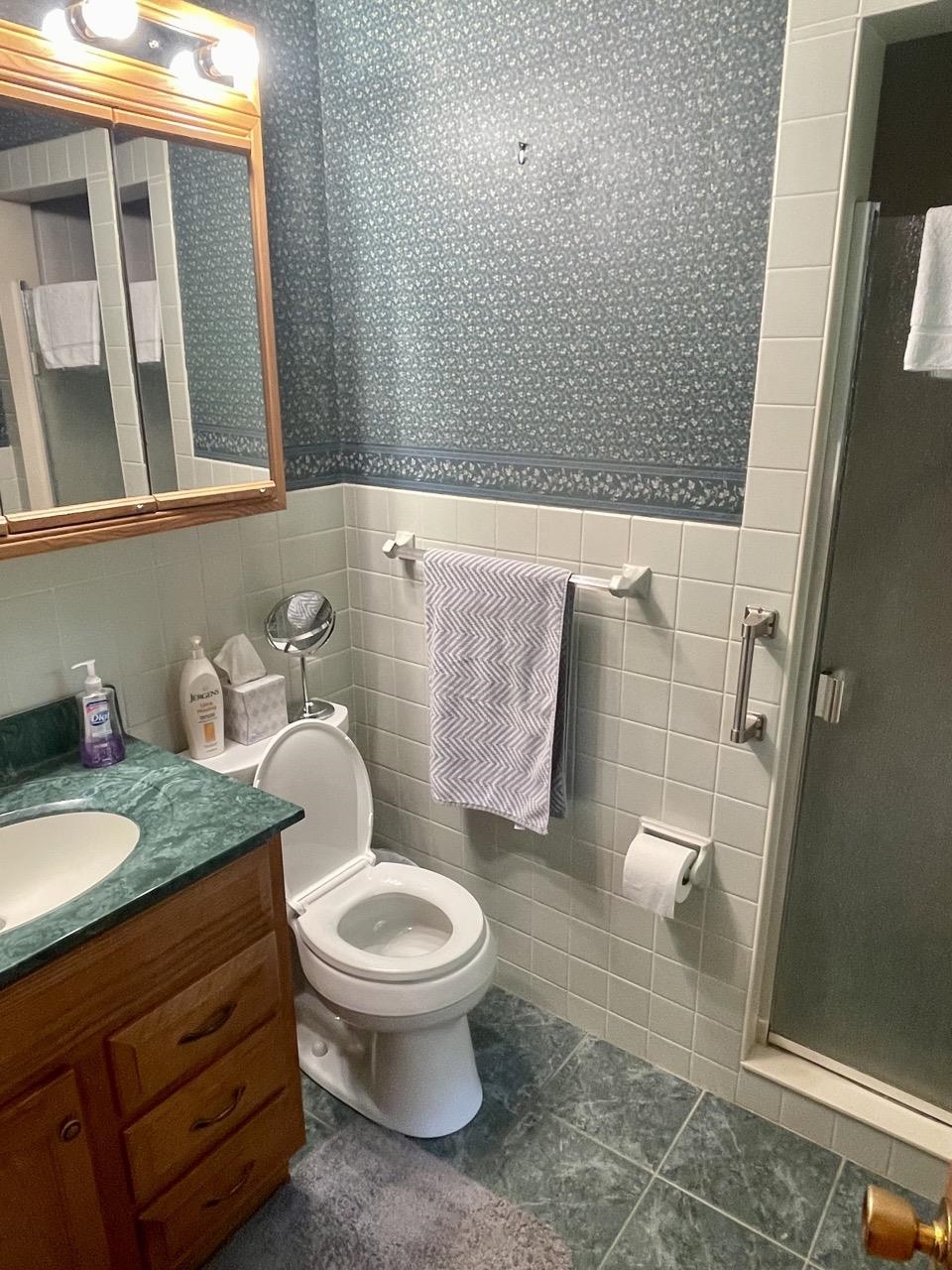 6840 Best Road Pecatonica, IL 61063 - Photo 15 of 29 a bathroom with a granite countertop toilet and a sink