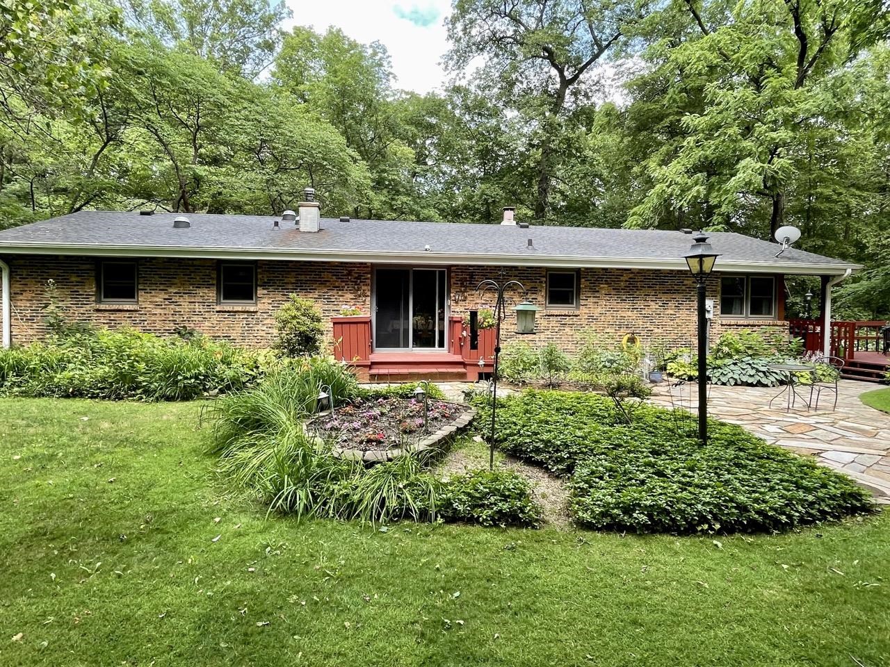 6840 Best Road Pecatonica, IL 61063 - Photo 24 of 29 a front view of a house with garden