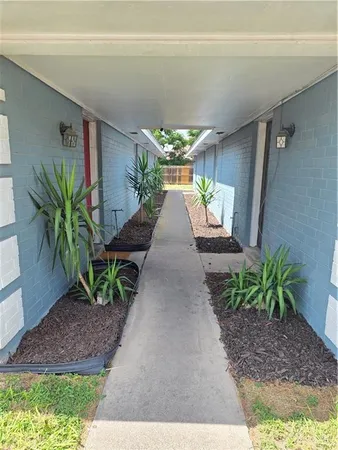 a porch with seating space and yard in back