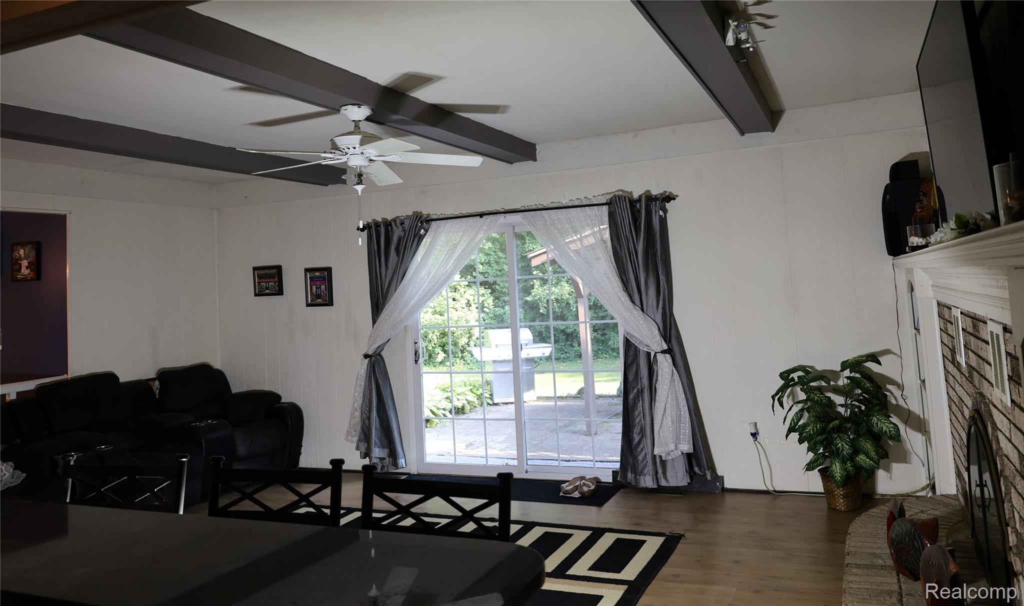 3333 Innsbrook Drive Rochester, MI 48309 - Photo 5 of 22 Living area featuring exposed ceiling beams and a ceiling fan