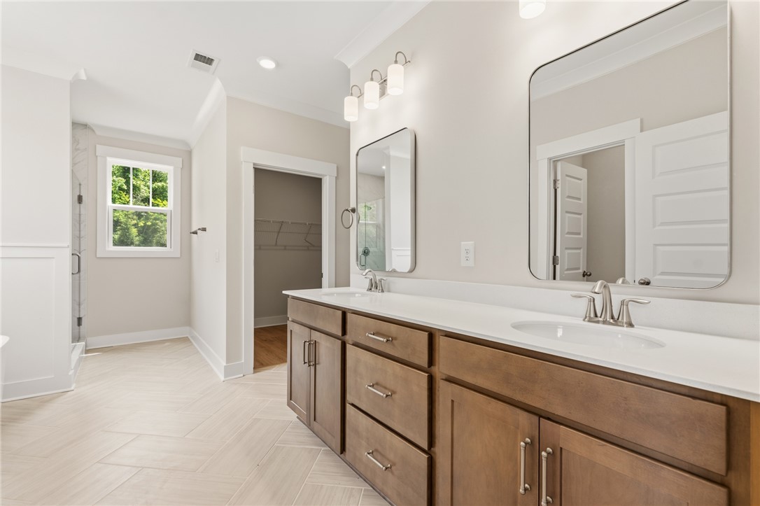 203 Timothy Court Anderson, SC 29621 - Photo 12 of 40 Double vanities and modern mirrors elevate this bright and airy primary bathroom.