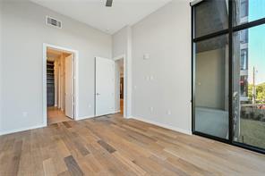 5921 Hiline Road, Unit 1203 Austin, TX 78734 - Photo 19 of 34 Rich hardwood flooring complements soaring ceilings and massive industrial-style windows framing city views.