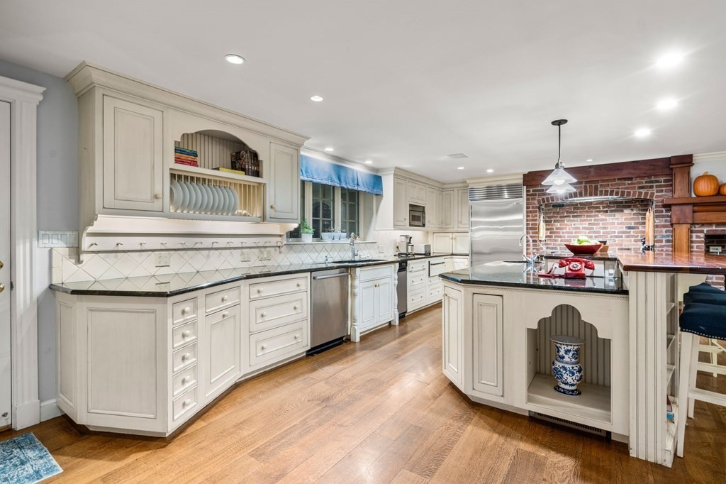 18 Audubon Road Wayland, MA 01778 - Photo 17 of 41 a kitchen with granite countertop a sink cabinets and wooden floor