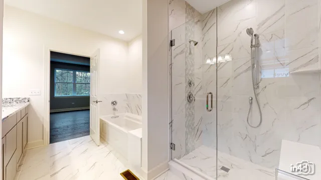 a bathroom with a bathtub and a shower