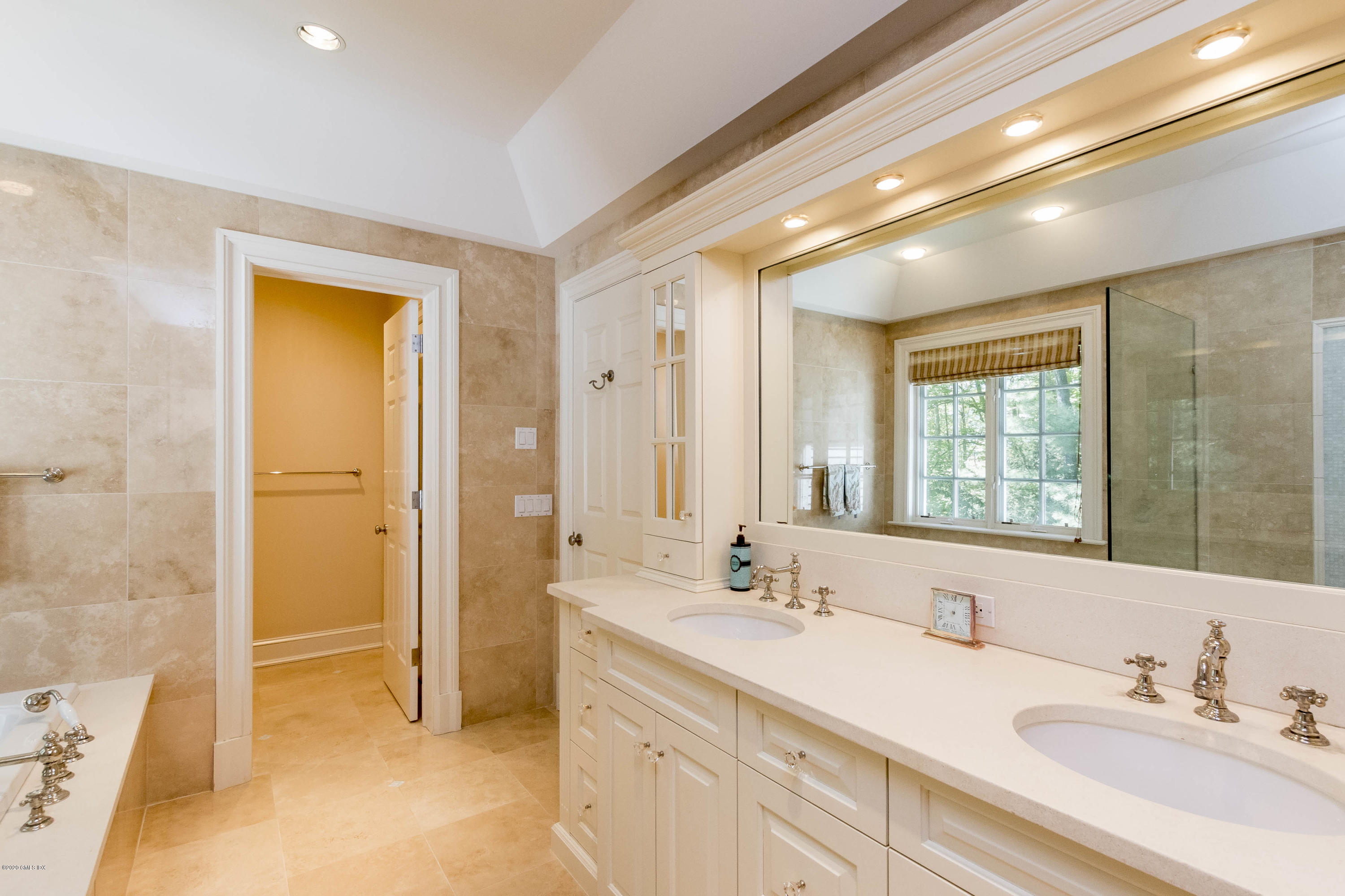 8 Hockanum Road Westport, CT 06880 - Photo 23 of 41 a spacious bathroom with a double vanity sink a mirror and a bathtub