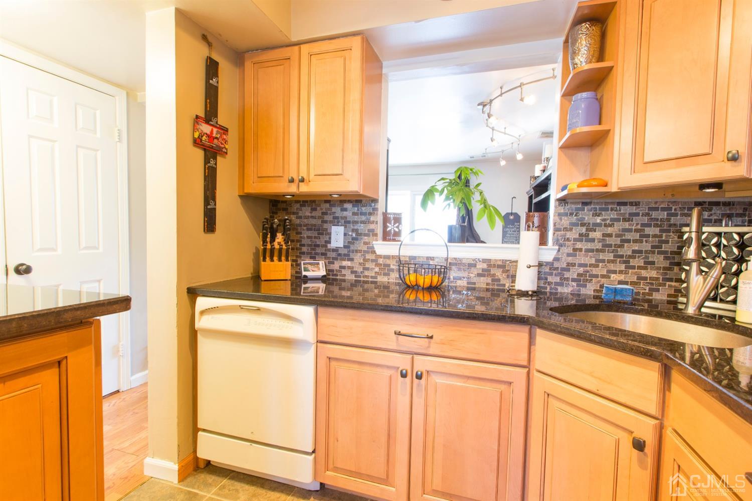 59 La Rue Lane East Brunswick, NJ 08816 - Photo 14 of 18 a kitchen with stainless steel appliances granite countertop a sink a stove and a microwave