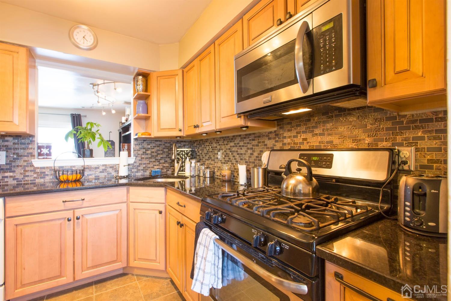 59 La Rue Lane East Brunswick, NJ 08816 - Photo 15 of 18 a kitchen with granite countertop a stove and a sink